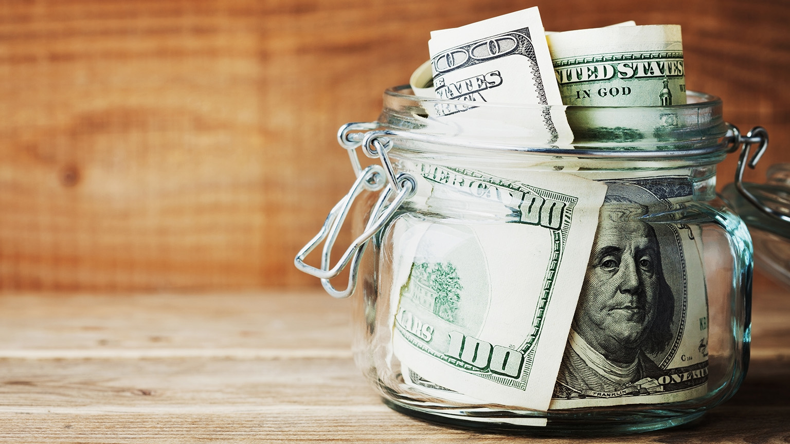 Money in a jar on a desk